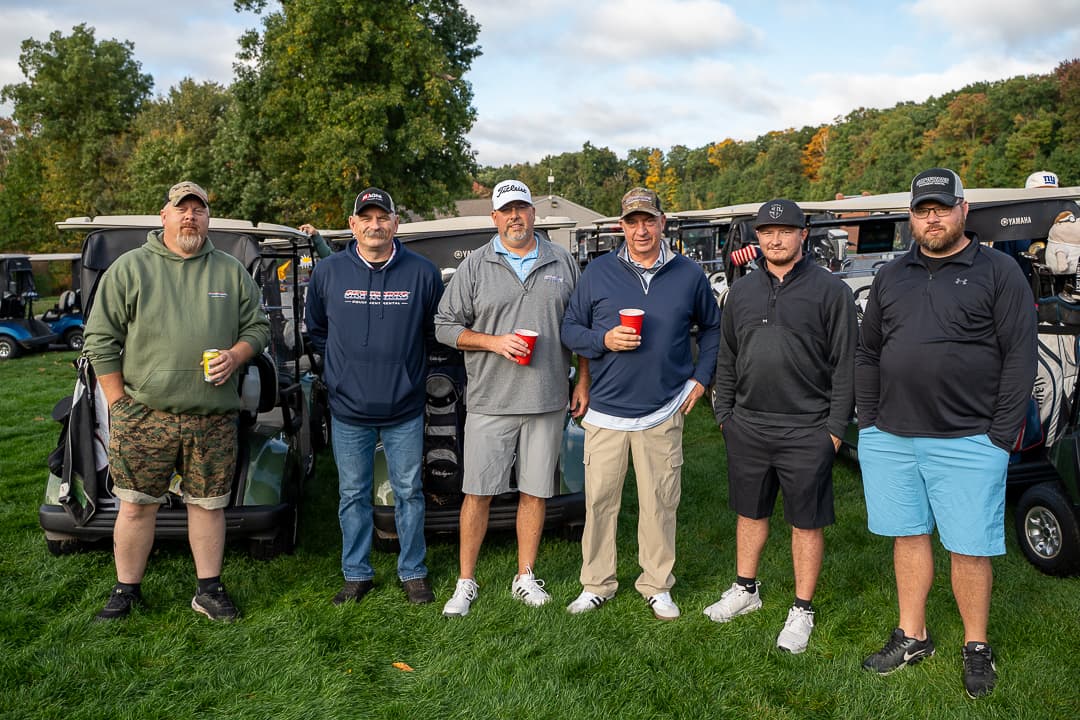 A foursome posing on the course at the Live Like Brent Classic.