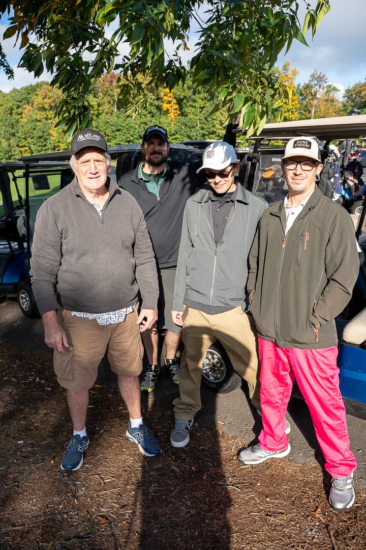 Three golfers posing together before play at the Live Like Brent Classic.